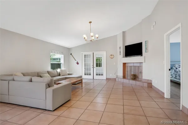 a living room with furniture a flat screen tv and a fireplace