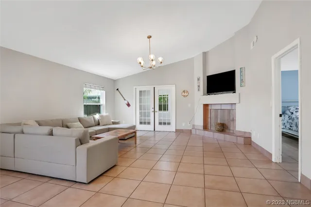 a living room with furniture a flat screen tv and a fireplace