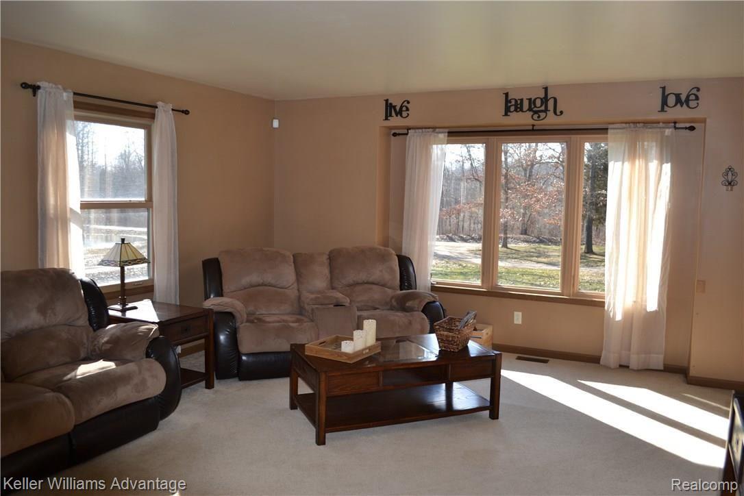 8183 Chambers Road Pinckney, MI 48169 - Photo 6 of 20 The living room features great light on all sides.