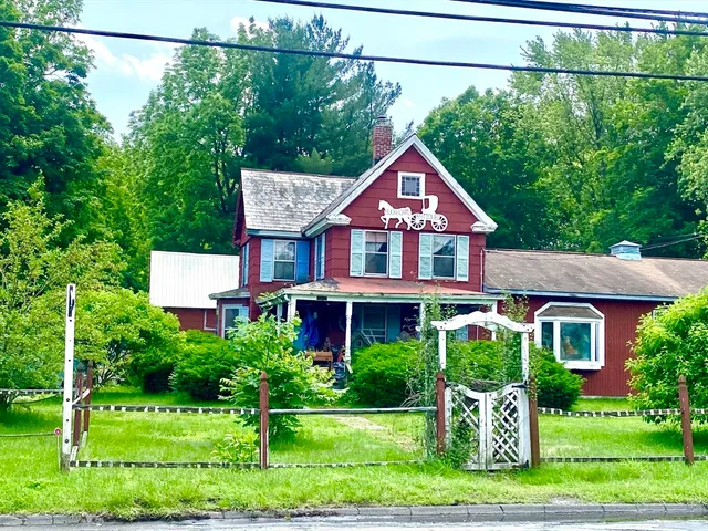 a view of a house with a yard and sitting area