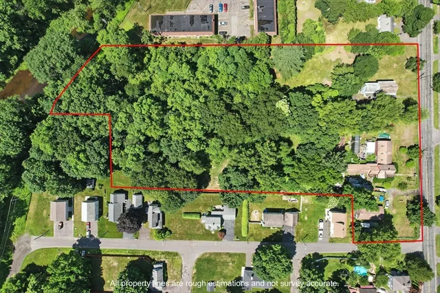 an aerial view of a house with garden space and street view