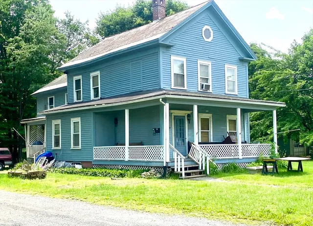 an aerial view of a house with swimming pool and garden