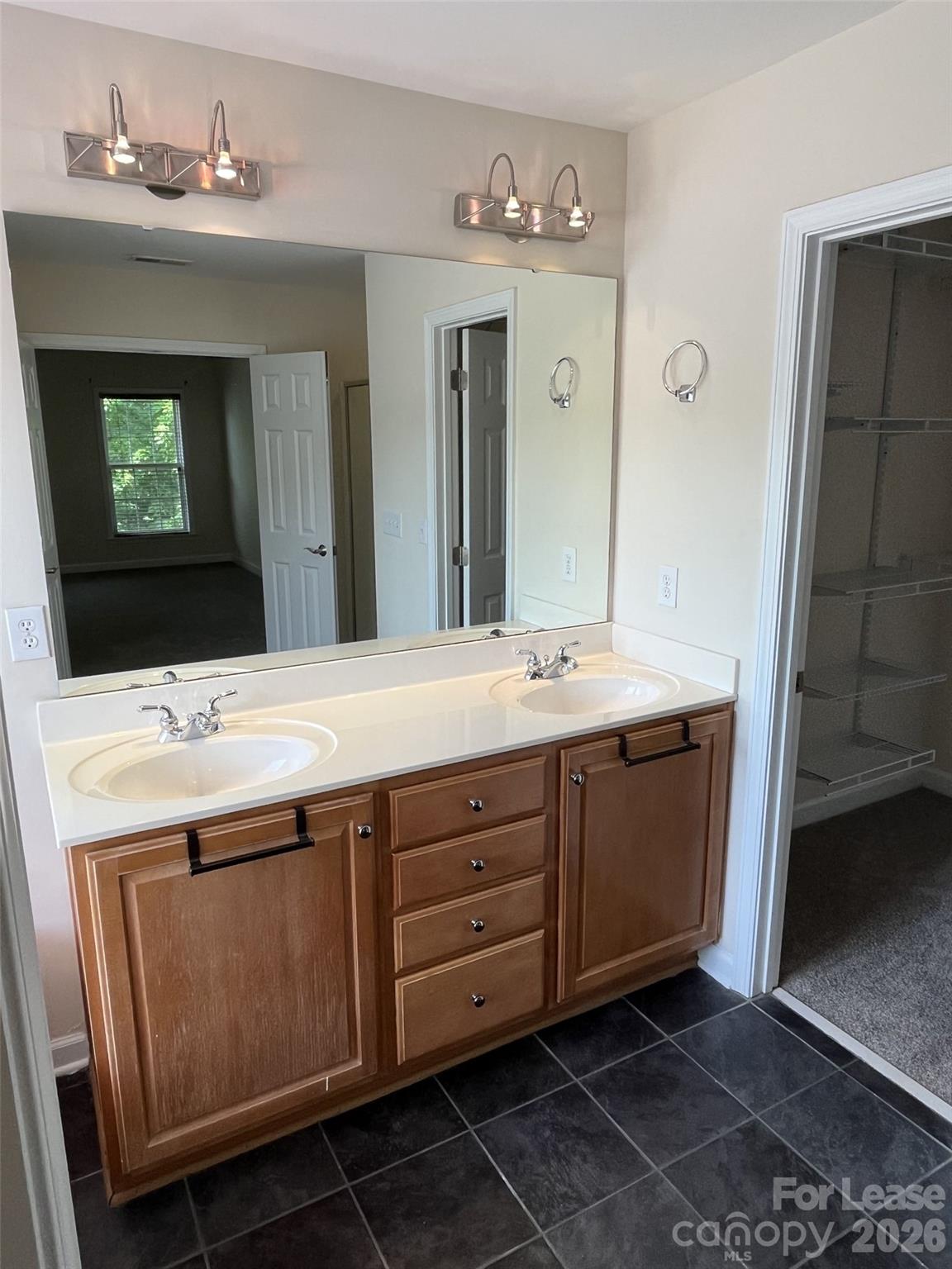8531 Camberly Road Huntersville, NC 28078 - Photo 17 of 32 a bathroom with a double vanity sink and a mirror