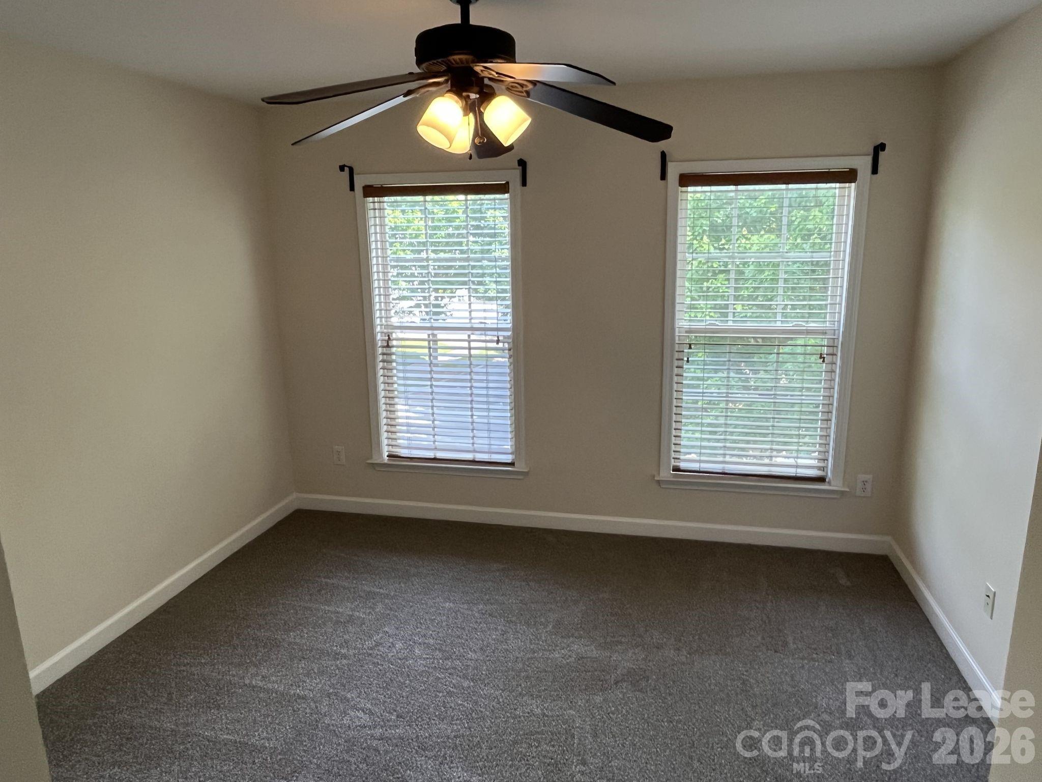 8531 Camberly Road Huntersville, NC 28078 - Photo 22 of 32 an empty room with a window and chandelier fan