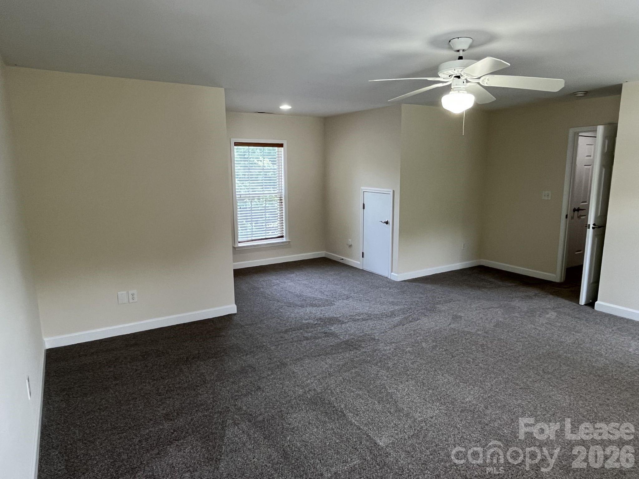 8531 Camberly Road Huntersville, NC 28078 - Photo 26 of 32 an empty room with windows and fan