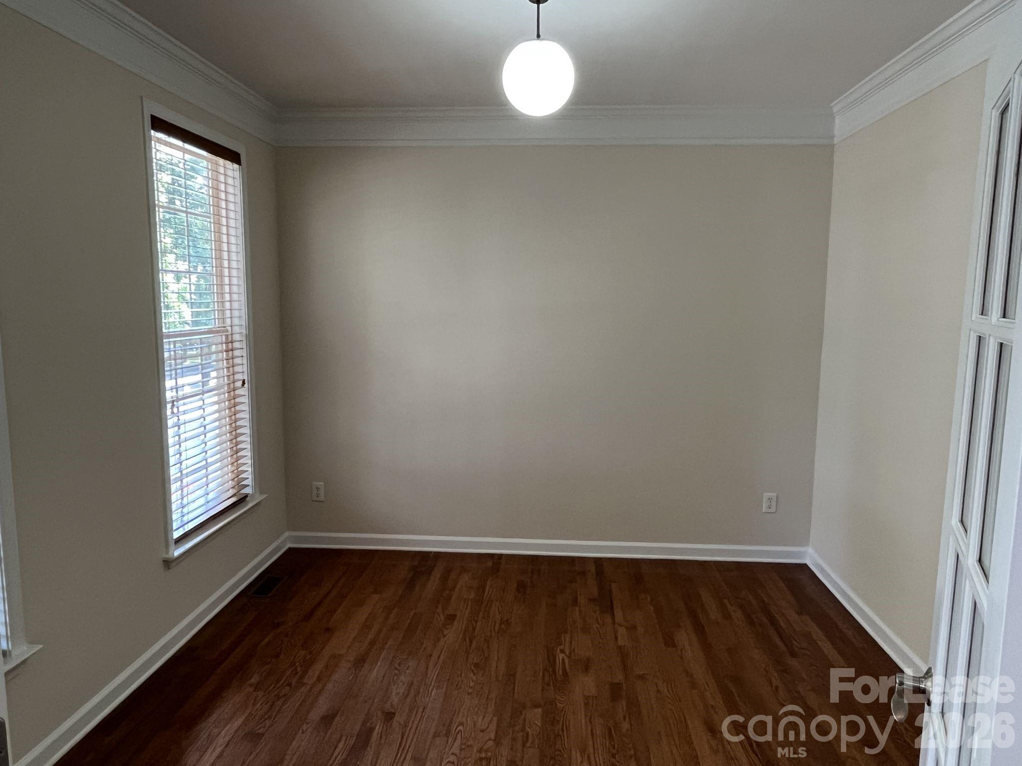 8531 Camberly Road Huntersville, NC 28078 - Photo 5 of 32 a view of an empty room with wooden floor and a window