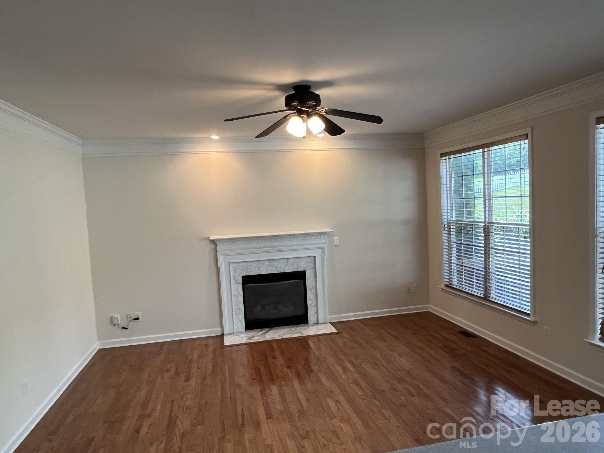 8531 Camberly Road Huntersville, NC 28078 - Photo 6 of 32 an empty room with chandelier fan and windows