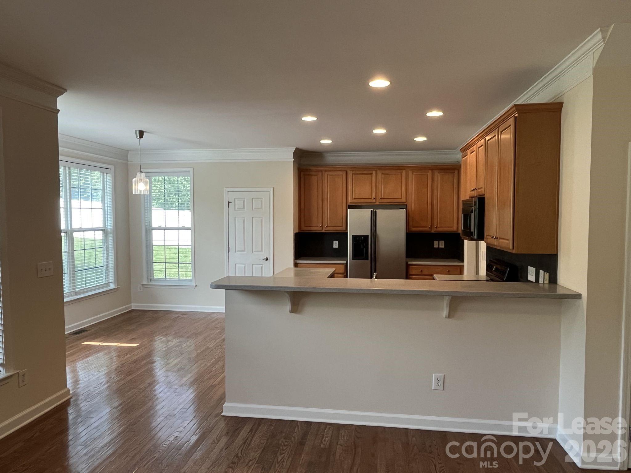 8531 Camberly Road Huntersville, NC 28078 - Photo 8 of 32 a large kitchen with stainless steel appliances a large counter top a stove and a refrigerator