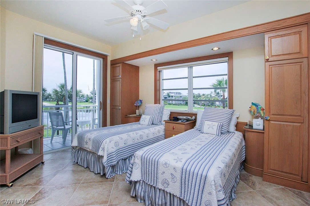 1251 South Seas Plantation Road Captiva, FL 33924 - Photo 15 of 24 a bedroom with a bed and a flat screen tv