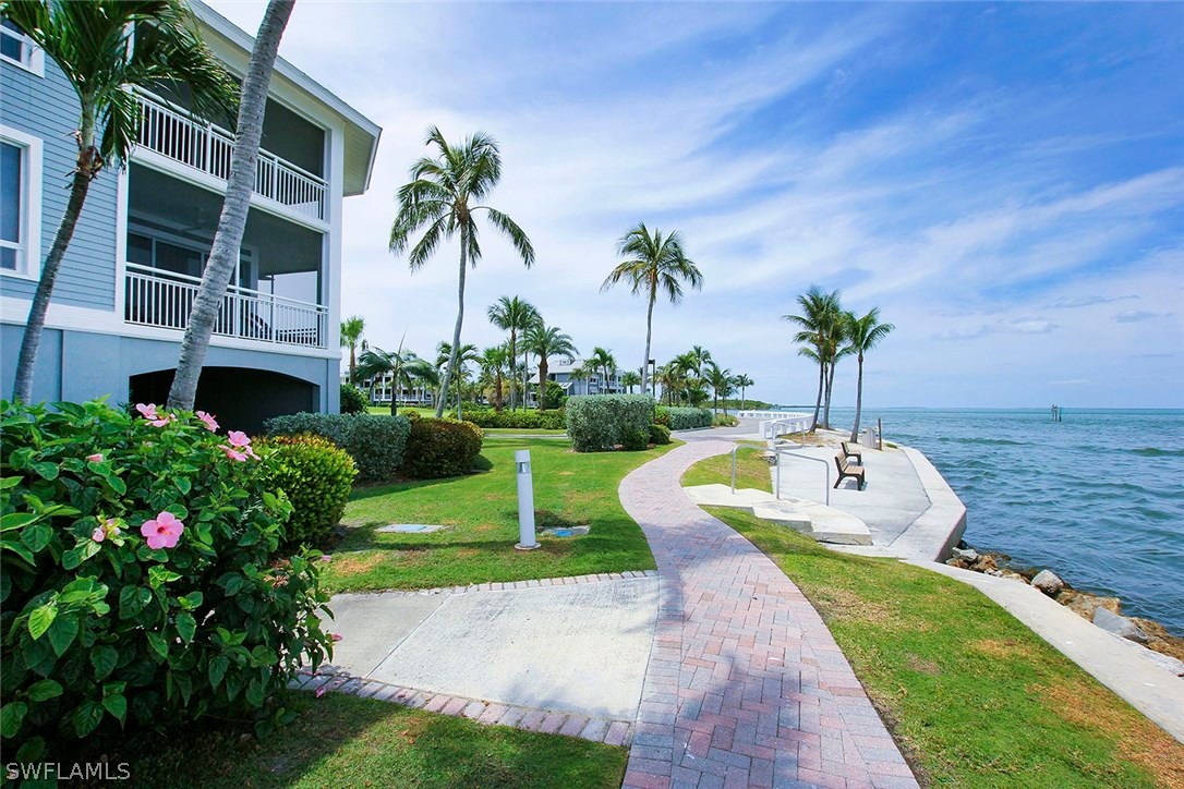 1251 South Seas Plantation Road Captiva, FL 33924 - Photo 21 of 24 a view of a swimming pool with a garden and plants