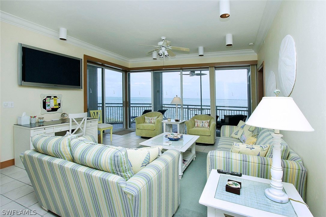 1251 South Seas Plantation Road Captiva, FL 33924 - Photo 3 of 24 a living room with furniture a flat screen tv and a chandelier