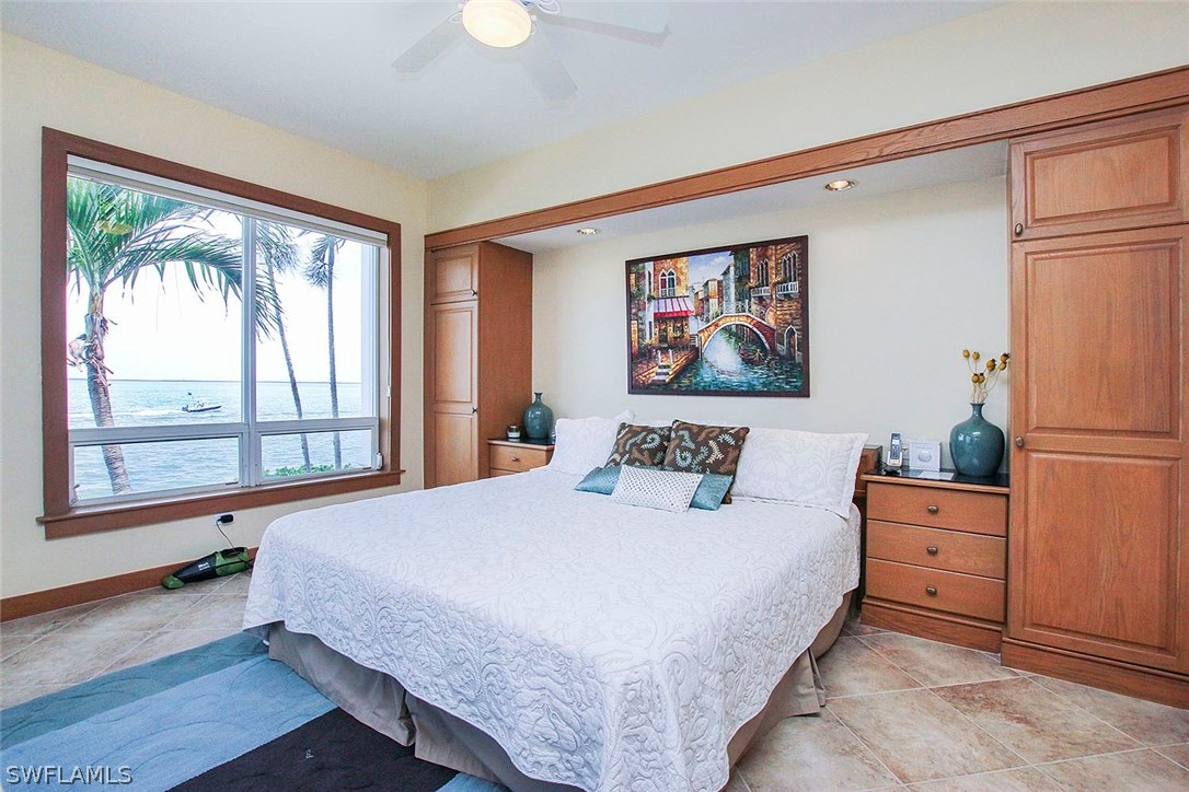 1251 South Seas Plantation Road Captiva, FL 33924 - Photo 10 of 24 a bedroom with a large bed and a large window