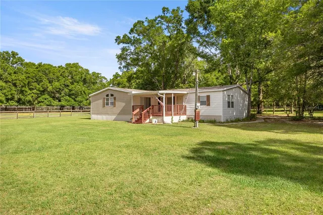 a view of a house with backyard and garden