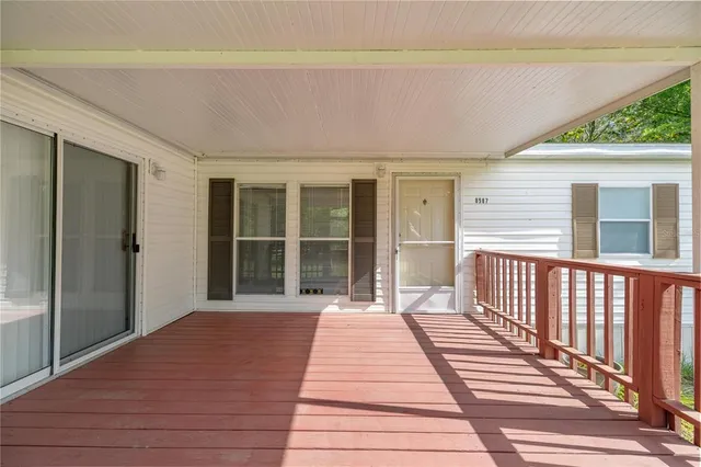 a view of a balcony with wooden floor