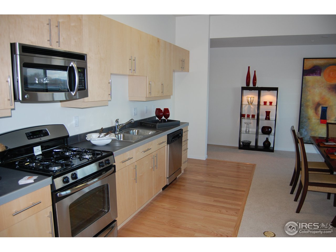 204 Maple Street, Unit 403 Fort Collins, CO 80521 - Photo 3 of 14 a kitchen with a stove and a refrigerator