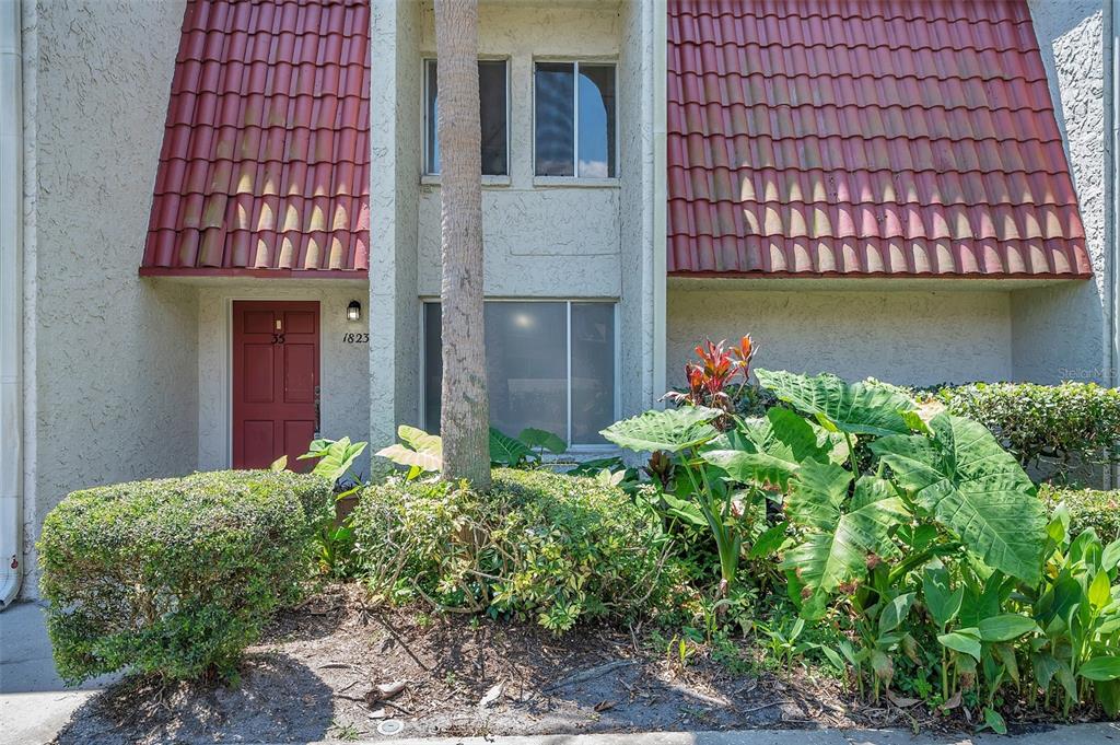 a house with a flower garden in front of it