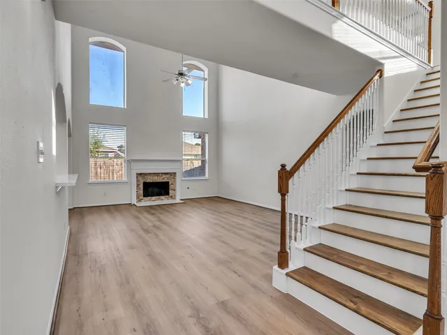 a view of a livingroom with wooden floor and fireplace