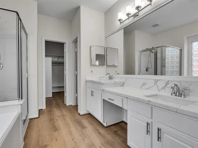 a bathroom with a double vanity sink and a mirror