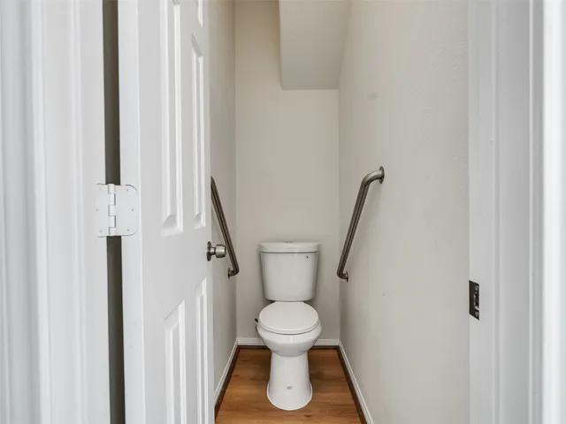 a white toilet sitting next to a small white tub
