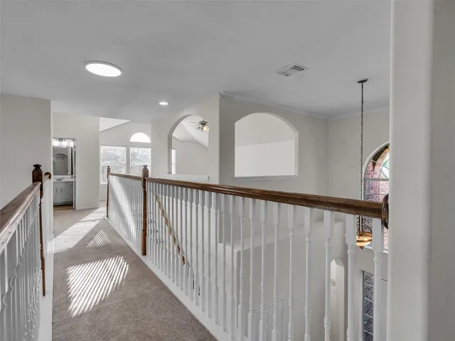 a view of a hallway with a large window and stairs