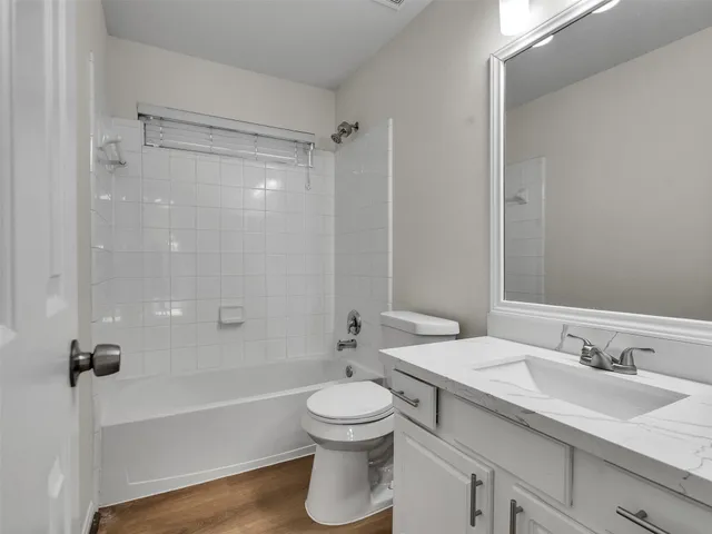 a bathroom with a sink toilet tub and shower