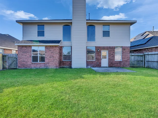 a view of a back yard of the house with a yard