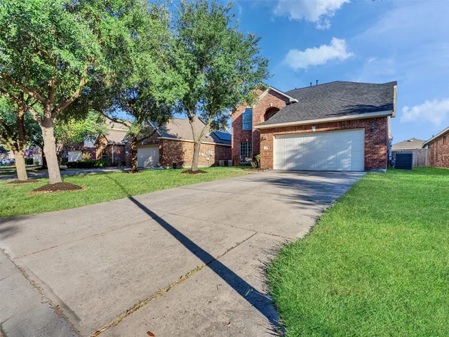 a front view of house with yard and green space