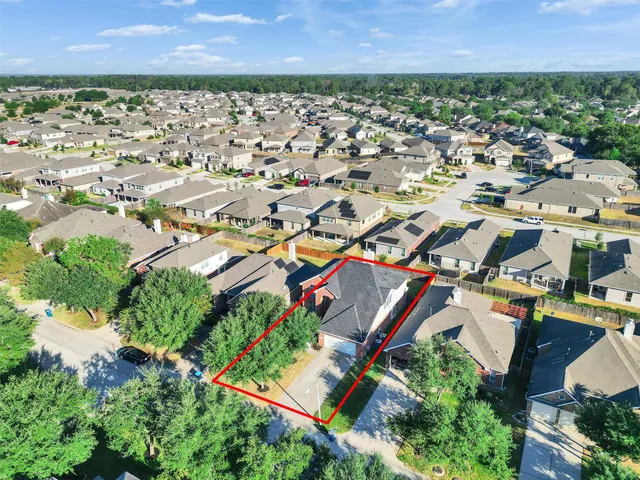 an aerial view of residential houses with outdoor space