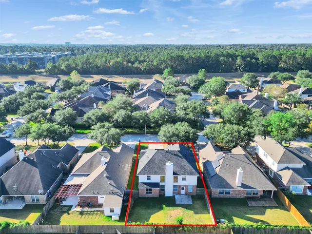 an aerial view of residential houses with outdoor space and swimming pool