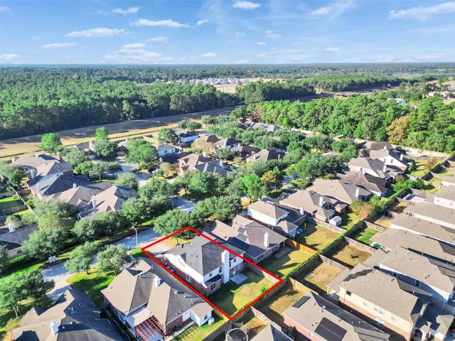 an aerial view of multiple house with a yard