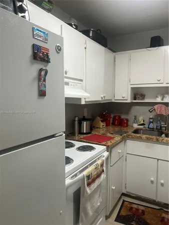 a kitchen with stainless steel appliances granite countertop a sink and a stove