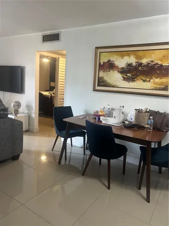 a living room with furniture and a painting on the wall