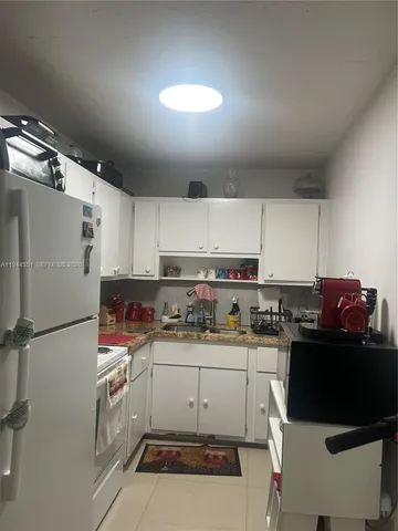 a kitchen with a sink appliances and cabinets