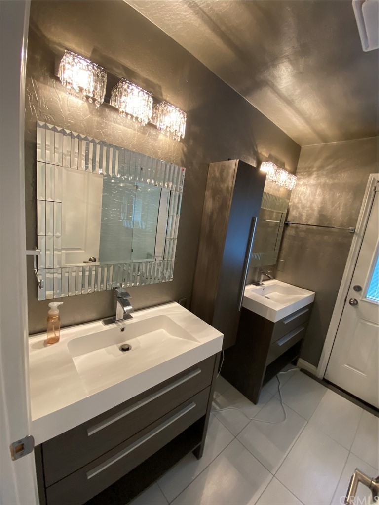 5321 Strasbourg Avenue Irvine, CA 92604 - Photo 18 of 28 a bathroom with a sink and mirror
