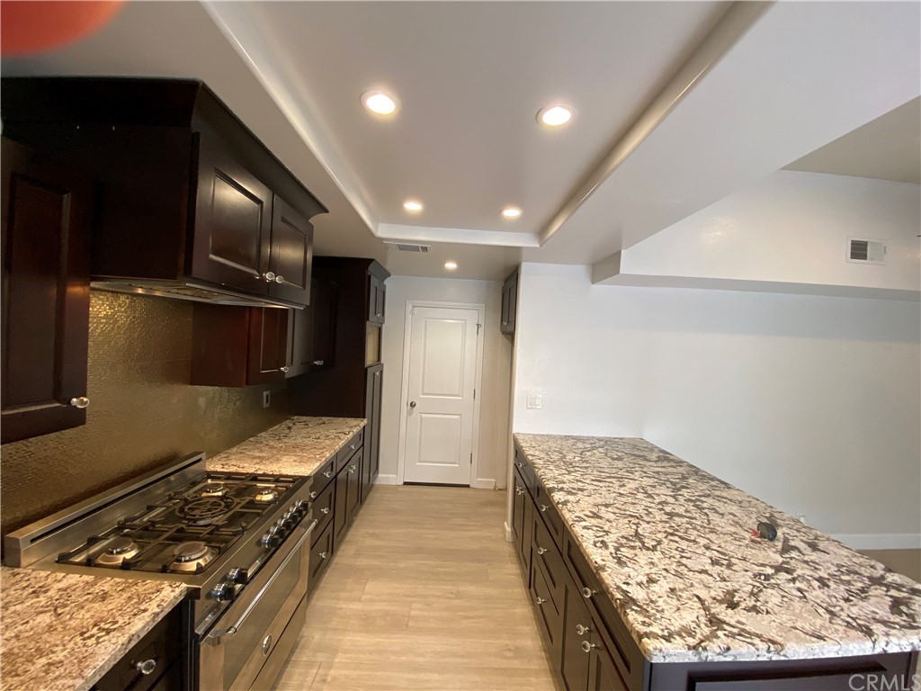 5321 Strasbourg Avenue Irvine, CA 92604 - Photo 8 of 28 a kitchen with stainless steel appliances granite countertop a stove and a refrigerator