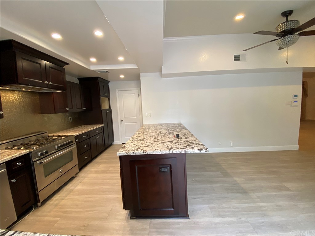 5321 Strasbourg Avenue Irvine, CA 92604 - Photo 10 of 28 a kitchen with stainless steel appliances granite countertop a stove and a refrigerator