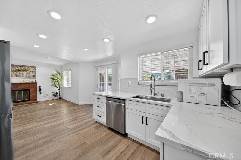 19610 Vega Way Rowland Heights, CA 91748 - Photo 4 of 30 a kitchen with stainless steel appliances granite countertop a sink cabinets and wooden floor