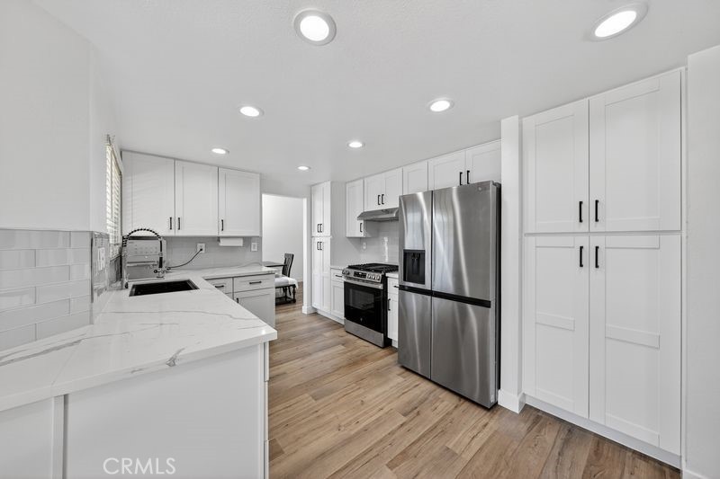 19610 Vega Way Rowland Heights, CA 91748 - Photo 5 of 30 a kitchen with a refrigerator a stove top oven and wooden floor