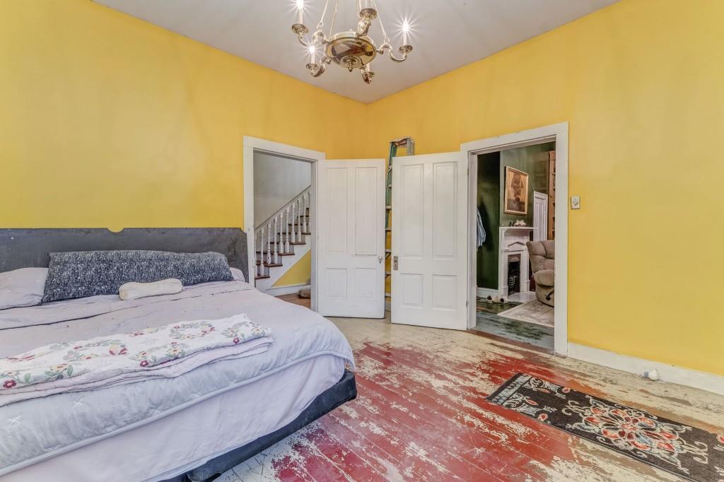 1006 Avenue A Rome, GA 30165 - Photo 22 of 61 a spacious bedroom with a bed and a chandelier