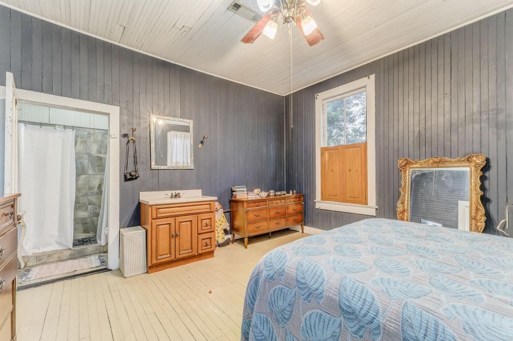 1006 Avenue A Rome, GA 30165 - Photo 51 of 61 a bedroom with a large bed and a chandelier