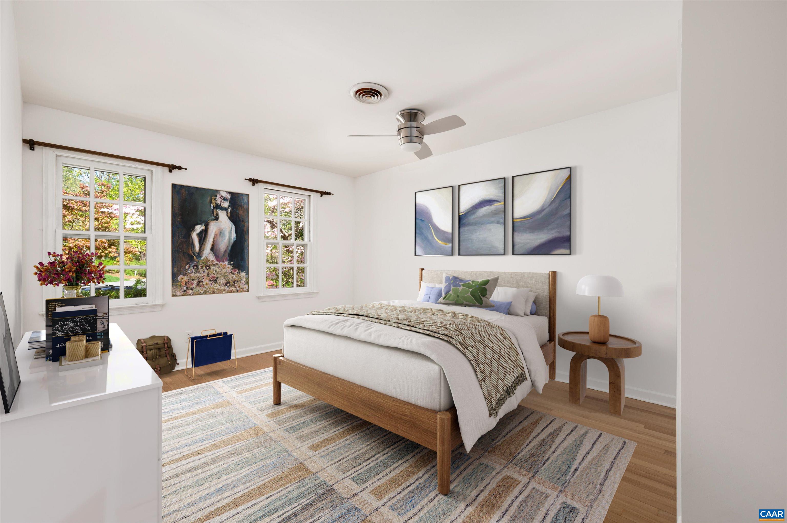 a bedroom with a bed wooden floor and window