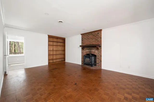 an empty room with furniture and a fireplace