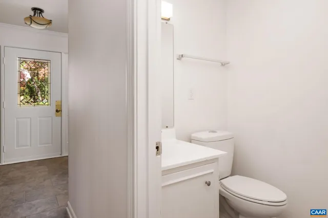 a white toilet sitting next to a bathroom sink