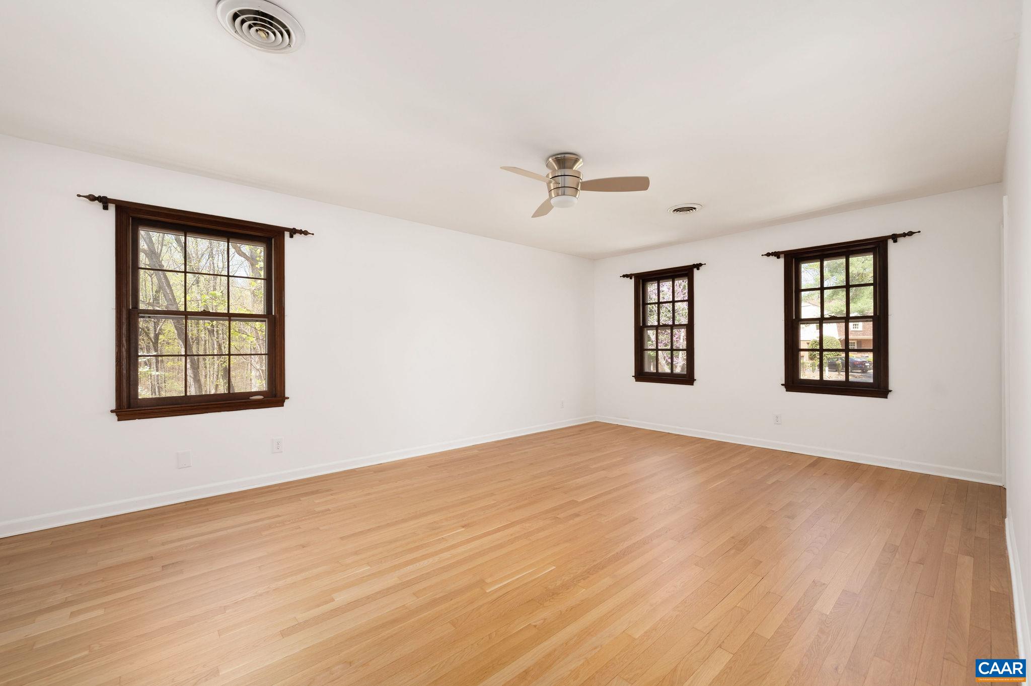 104 Smithfield Court, Unit A Charlottesville, VA 22901 - Photo 14 of 25 a view of an empty room with a window and wooden floor