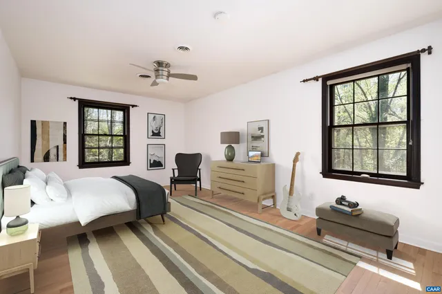 a bedroom with bed couch and window