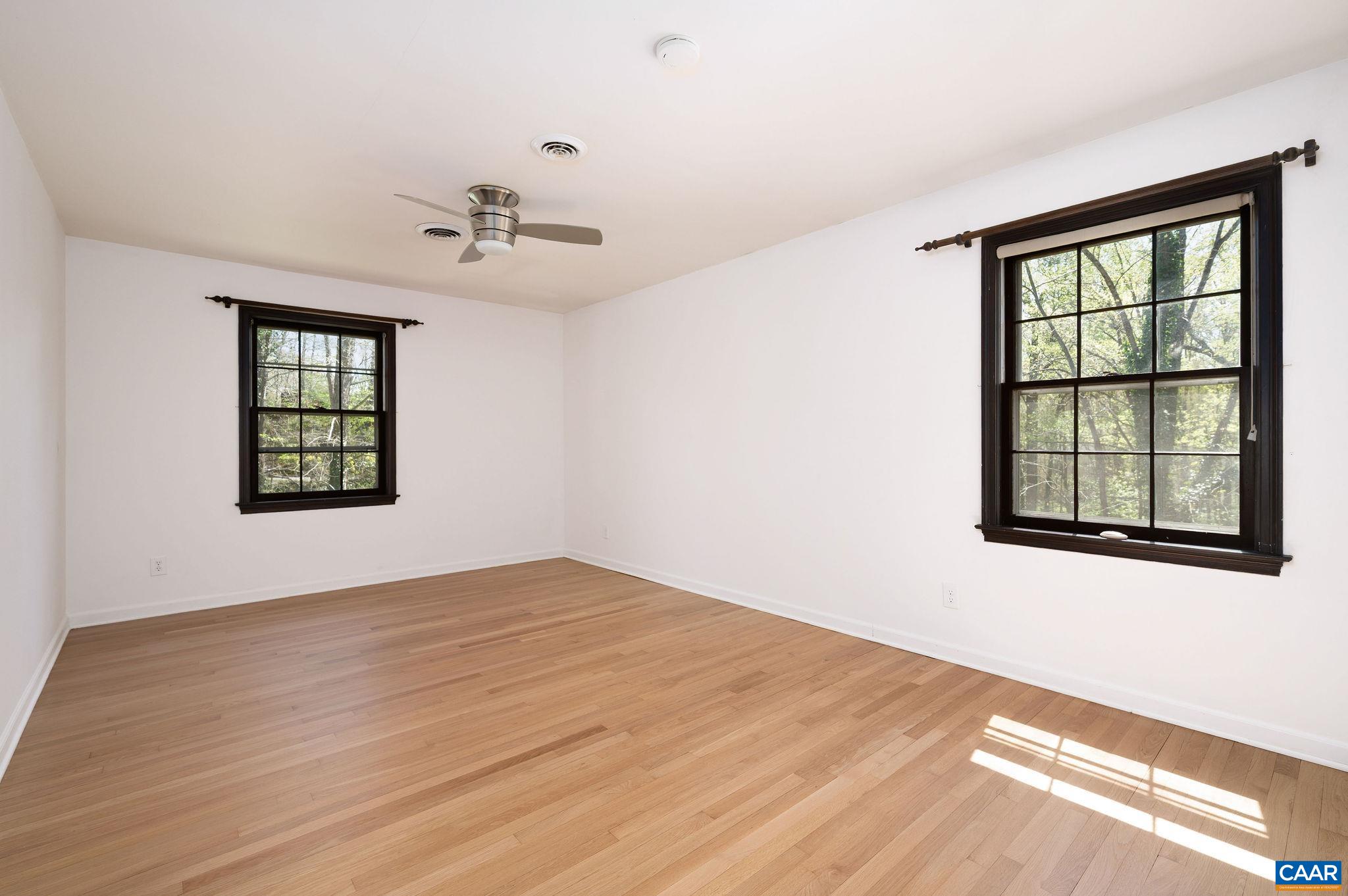 104 Smithfield Court, Unit A Charlottesville, VA 22901 - Photo 18 of 25 a view of an empty room with a window and wooden floor