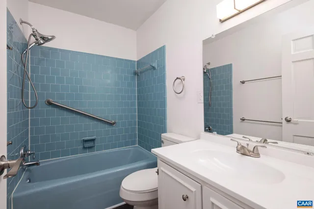 a bathroom with a sink toilet vanity and shower