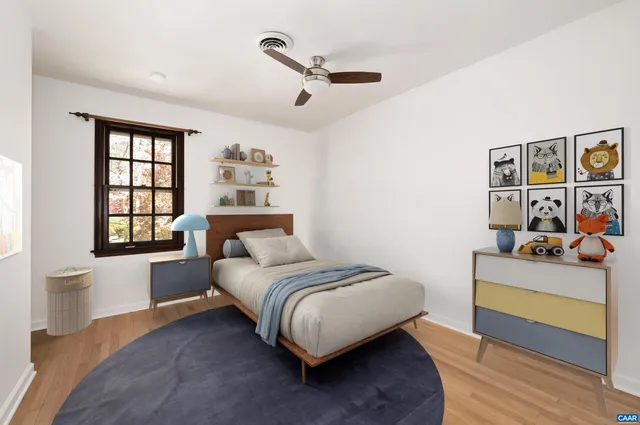 a bedroom with a bed couch and a window