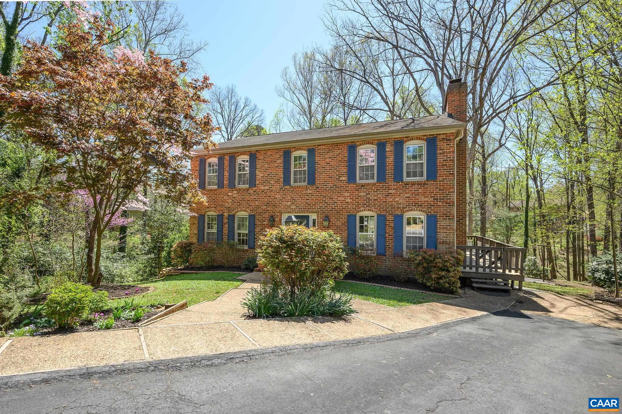 104 Smithfield Court, Unit A Charlottesville, VA 22901 - Photo 23 of 25 a front view of a house with a yard and a garage