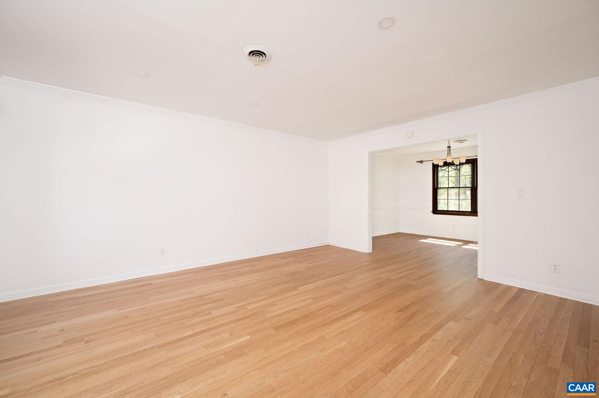 104 Smithfield Court, Unit A Charlottesville, VA 22901 - Photo 4 of 25 an empty room with wooden floor and windows